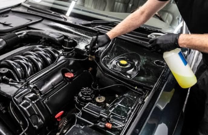 Gloss Boss detailer cleaning an engine bay with a dedicated degreaser spray