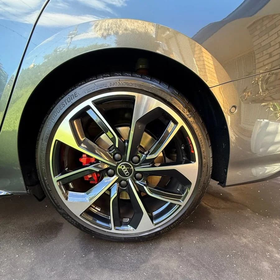 Audi alloy wheel, tyre and red brake caliper