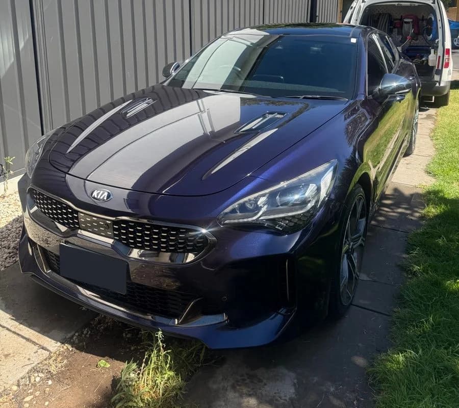 Purple Kia Stinger showing the bonnet reflections and front exterior