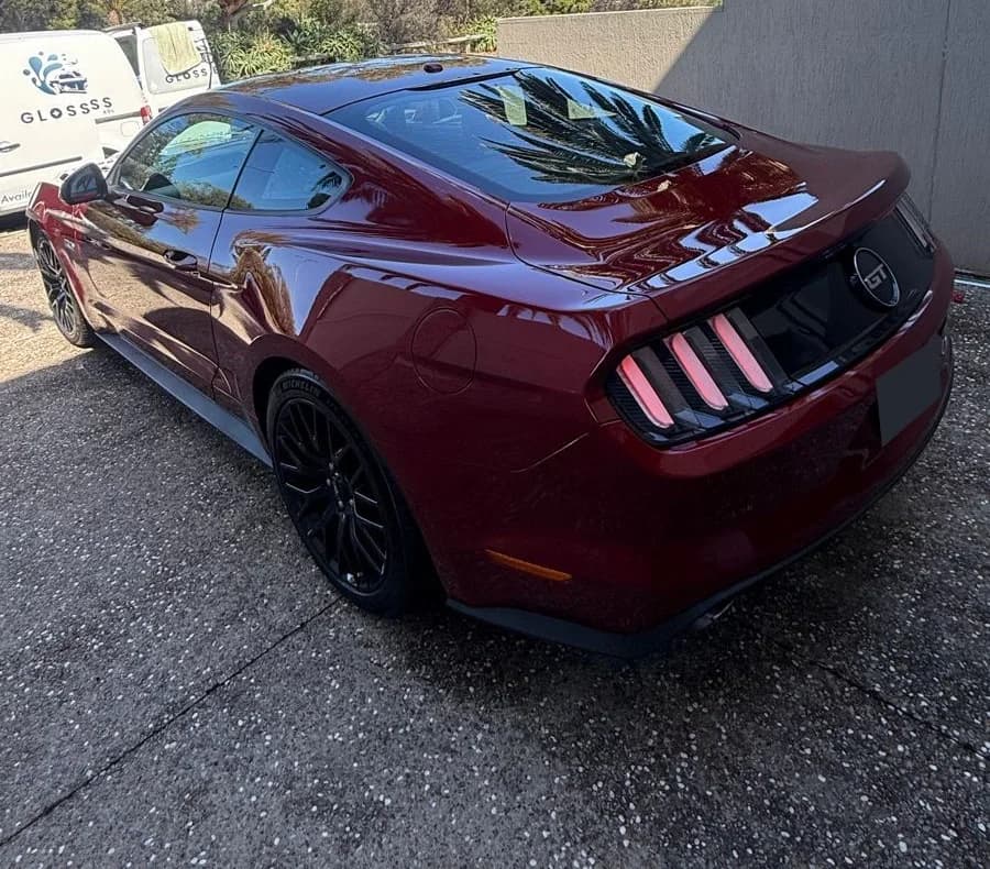 Red Ford Mustang viewed from the rear quarter